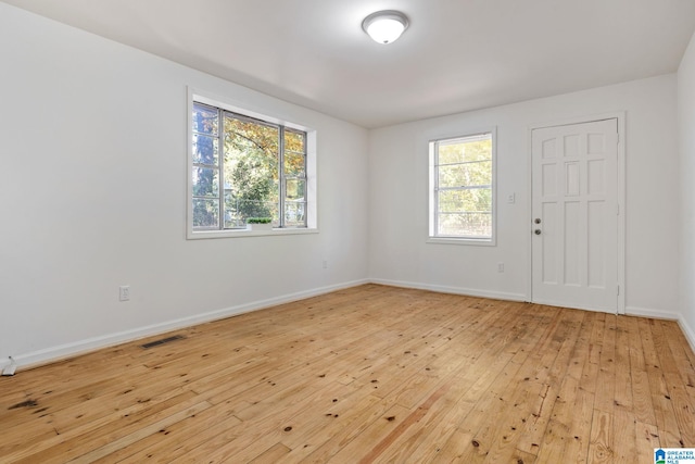 unfurnished room with light hardwood / wood-style floors