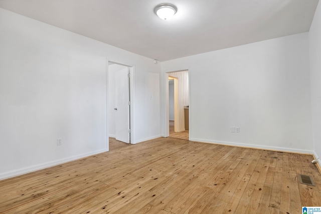 empty room with light hardwood / wood-style floors