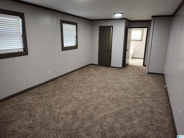 carpeted spare room with crown molding