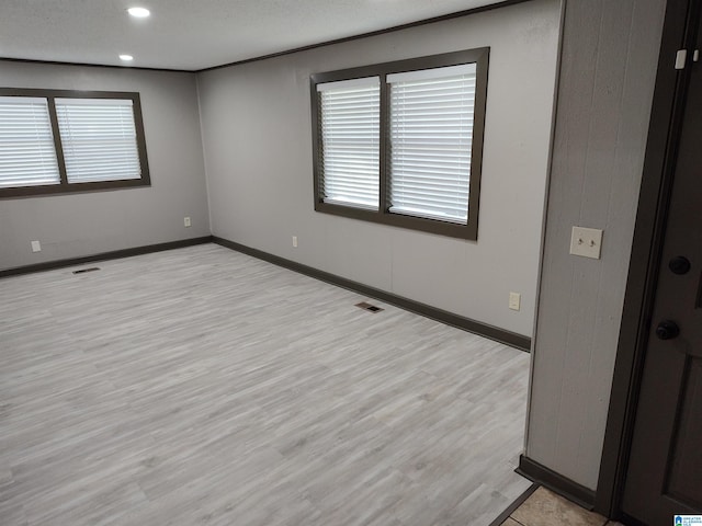 unfurnished room with light wood-type flooring