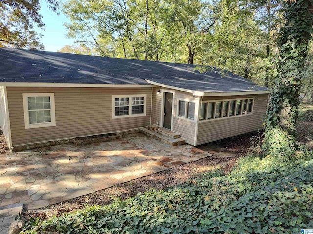 rear view of property featuring a patio area