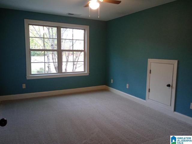 empty room featuring ceiling fan and carpet flooring