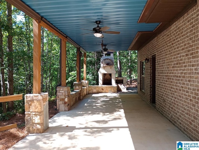 view of patio with exterior fireplace and ceiling fan