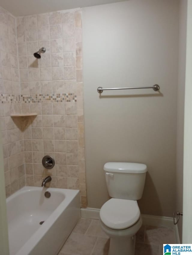 bathroom featuring toilet, tile patterned floors, and tiled shower / bath