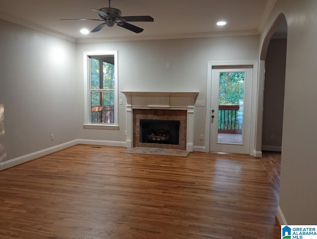 unfurnished living room with ornamental molding, wood-type flooring, and ceiling fan