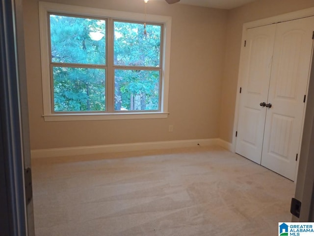 unfurnished bedroom featuring light carpet