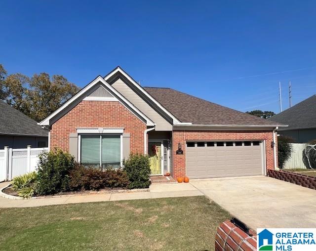 view of front of home featuring a front yard and a garage