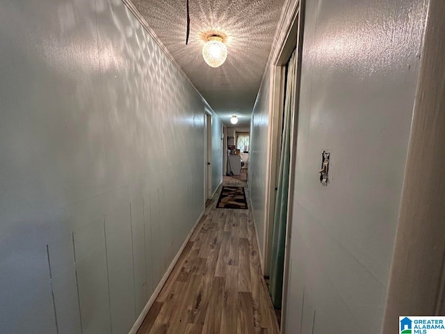 corridor with crown molding, hardwood / wood-style flooring, and wooden walls