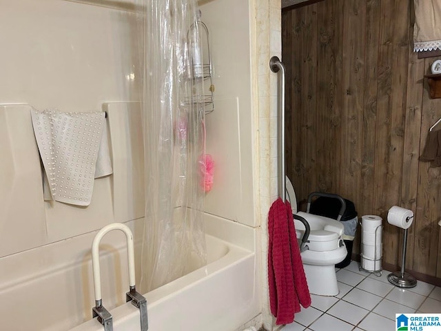 bathroom with shower / bath combo, toilet, tile patterned floors, and wooden walls