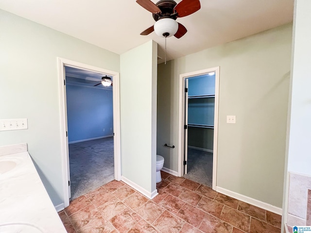 bathroom featuring ceiling fan, vanity, and toilet