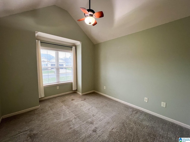 unfurnished room featuring ceiling fan, carpet flooring, and vaulted ceiling