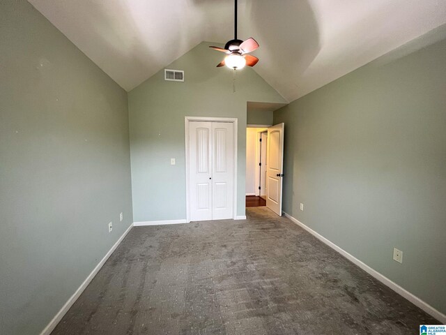 unfurnished bedroom featuring ceiling fan, a closet, vaulted ceiling, and carpet floors