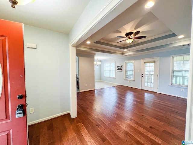 foyer with ceiling fan with notable chandelier, wood-type flooring, crown molding, and a tray ceiling