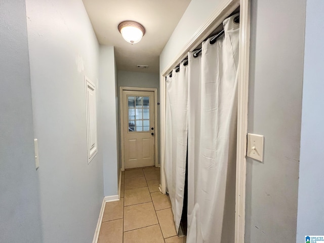 corridor with light tile patterned flooring