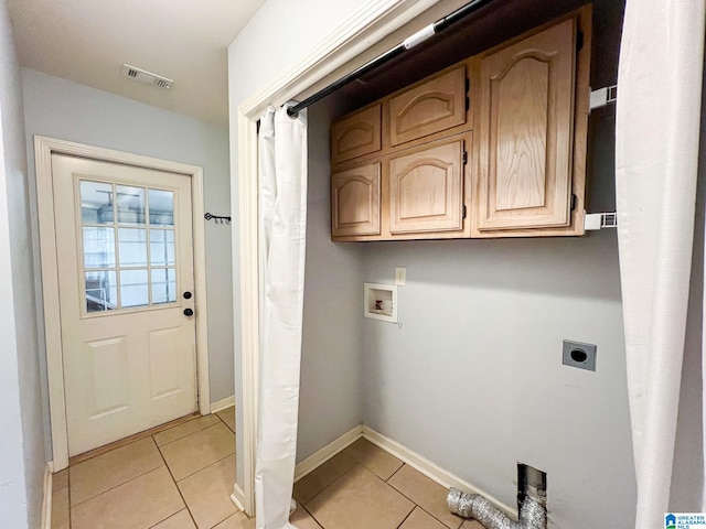 laundry area featuring cabinets, washer hookup, light tile patterned floors, and electric dryer hookup