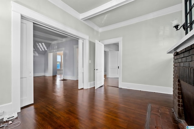 unfurnished living room with beam ceiling, ornamental molding, a brick fireplace, and dark hardwood / wood-style flooring