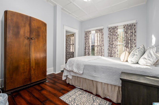 bedroom with dark wood-type flooring