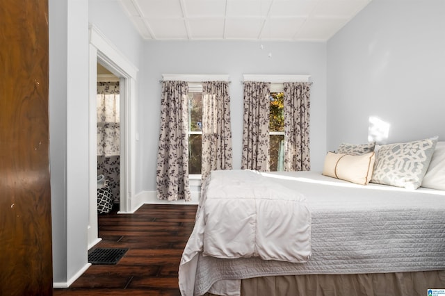 bedroom with dark hardwood / wood-style flooring