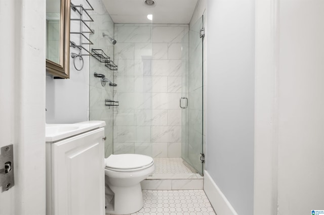 bathroom featuring vanity, a shower with shower door, toilet, and tile patterned flooring