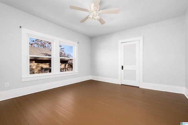 spare room featuring ceiling fan and dark hardwood / wood-style flooring