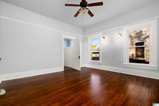 unfurnished room with dark hardwood / wood-style floors and ceiling fan