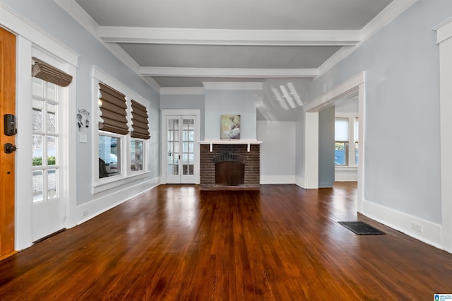 unfurnished living room with crown molding, wood-type flooring, beamed ceiling, and a brick fireplace