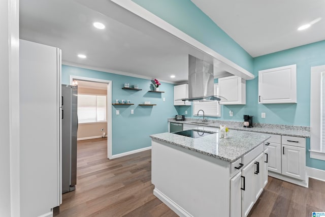 kitchen with island exhaust hood, white cabinets, sink, light hardwood / wood-style floors, and stainless steel appliances