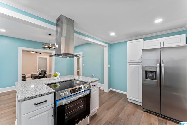 kitchen with island range hood, stainless steel appliances, white cabinets, crown molding, and light hardwood / wood-style flooring