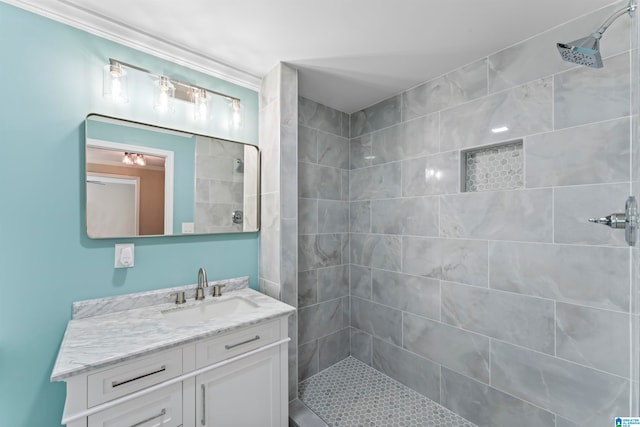 bathroom featuring vanity and tiled shower