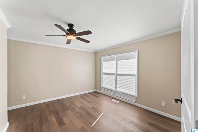 empty room featuring ceiling fan, ornamental molding, and hardwood / wood-style floors