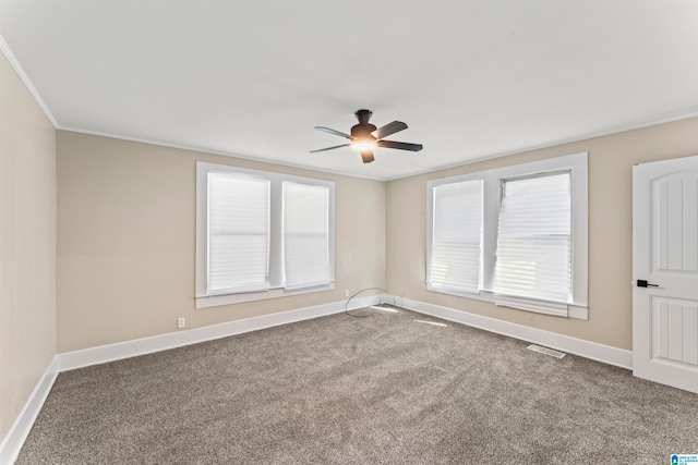 carpeted spare room with ornamental molding and ceiling fan