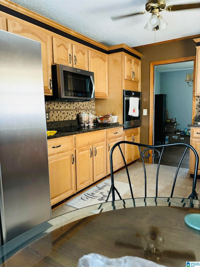 kitchen featuring light brown cabinets, decorative backsplash, ceiling fan, light tile patterned floors, and stainless steel appliances