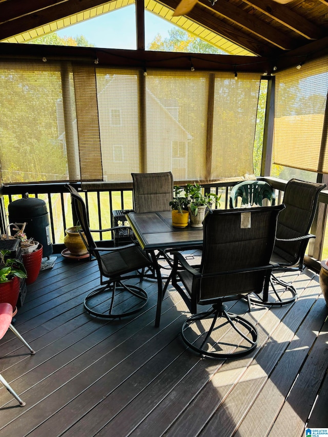 sunroom featuring vaulted ceiling with beams, wood ceiling, and plenty of natural light