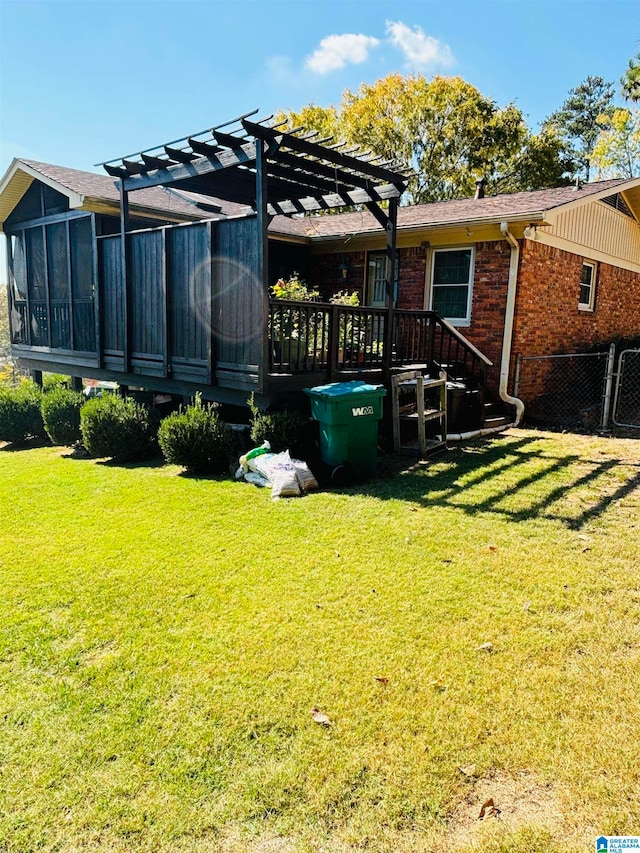 back of property featuring a sunroom, a lawn, and a pergola