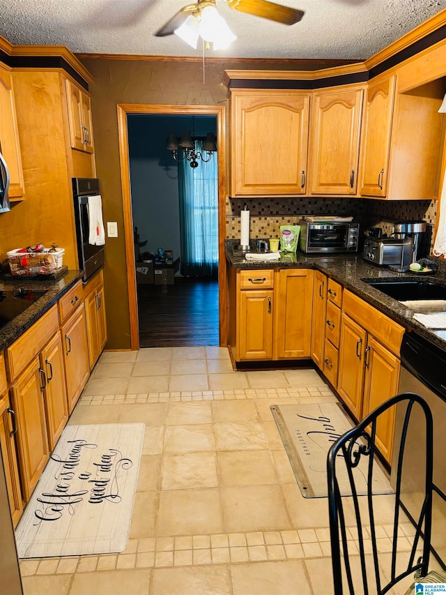 kitchen featuring oven, decorative backsplash, a textured ceiling, and stainless steel dishwasher