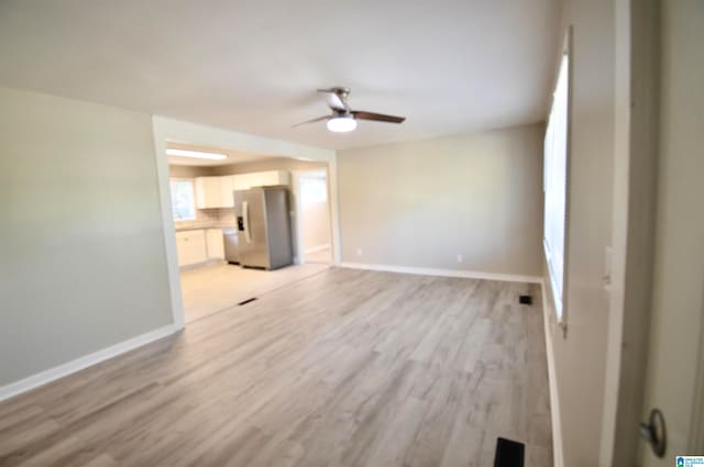 unfurnished living room with light hardwood / wood-style floors and ceiling fan