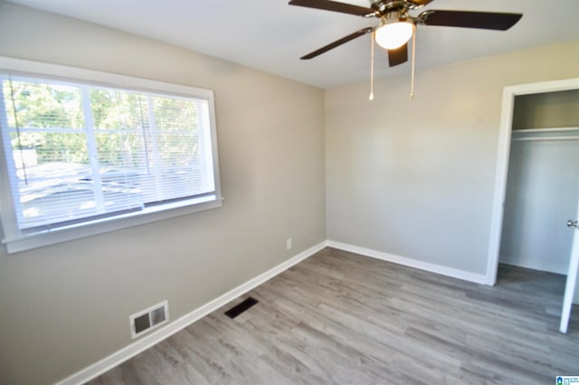 unfurnished bedroom featuring a closet, ceiling fan, and hardwood / wood-style flooring