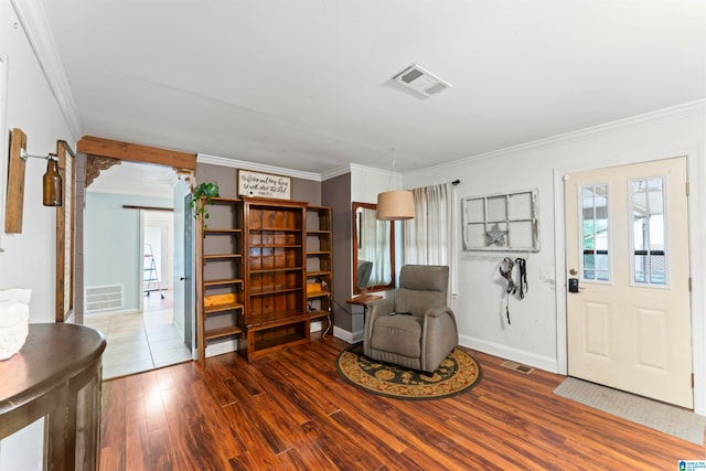 sitting room with dark hardwood / wood-style floors and crown molding