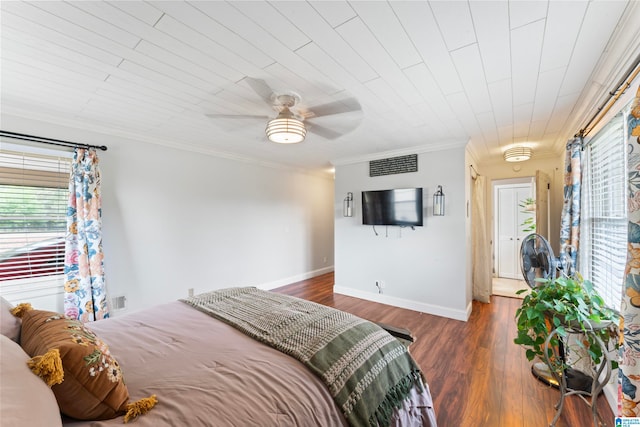 bedroom featuring dark hardwood / wood-style floors, ceiling fan, multiple windows, and ornamental molding