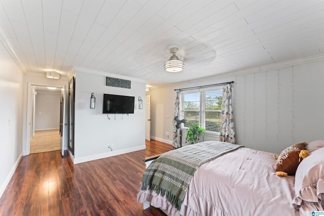 bedroom with crown molding and dark hardwood / wood-style flooring