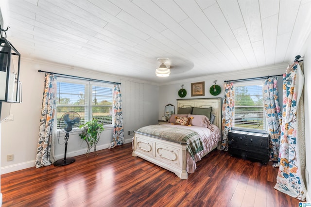 bedroom with ornamental molding, dark hardwood / wood-style flooring, multiple windows, and ceiling fan