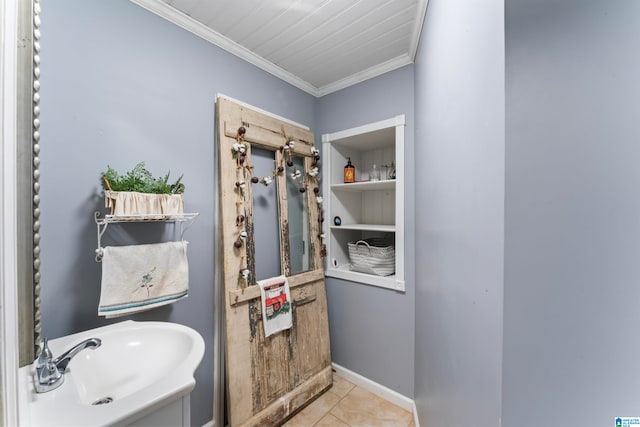 bathroom with tile patterned flooring, sink, and crown molding