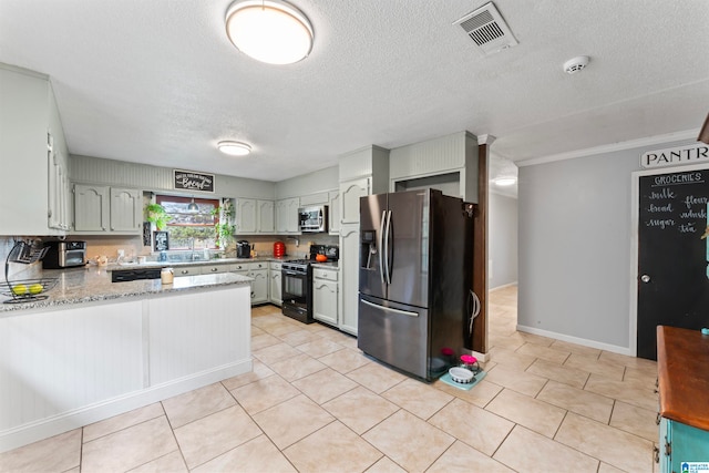 kitchen with kitchen peninsula, a textured ceiling, and appliances with stainless steel finishes