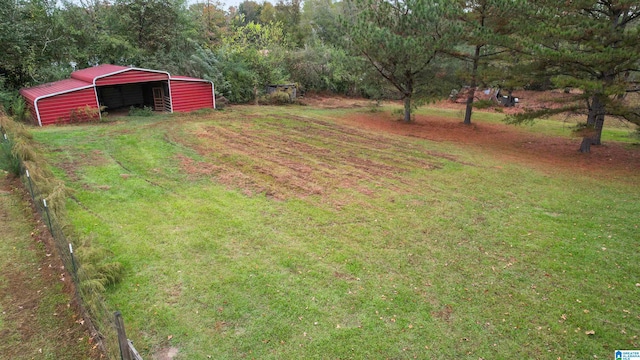 view of yard with an outdoor structure and a rural view