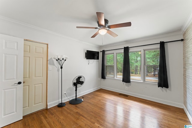 unfurnished room with ornamental molding, hardwood / wood-style flooring, and ceiling fan