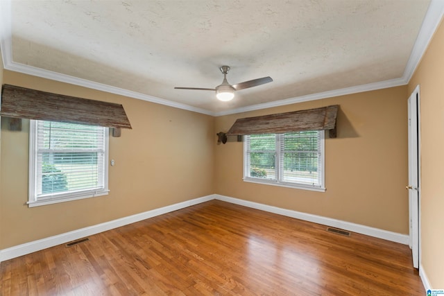 spare room featuring ornamental molding, a textured ceiling, hardwood / wood-style flooring, and ceiling fan