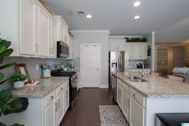 kitchen featuring sink, appliances with stainless steel finishes, dark hardwood / wood-style floors, and backsplash