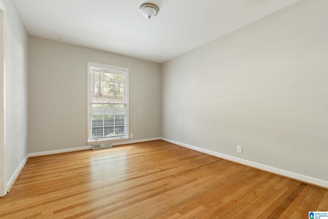 unfurnished room with light wood-type flooring