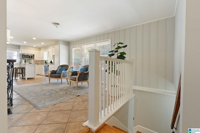 interior space with ornamental molding and light tile patterned flooring