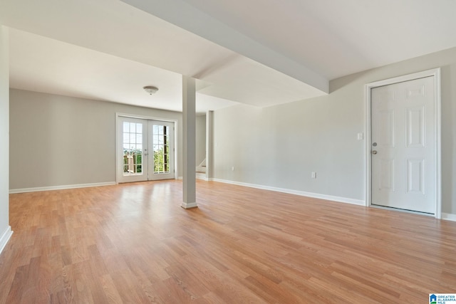 unfurnished living room with french doors and light wood-type flooring